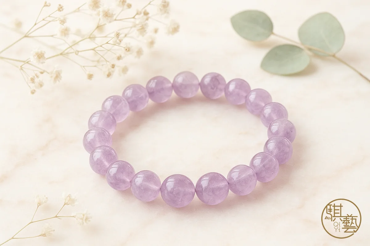 An amethyst bracelet alongside a piece of rough amethyst